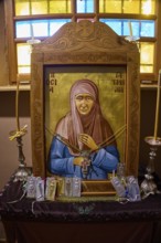 Icon of Panagia Kyra, Religious icon on an altar with candles and decorative details in an