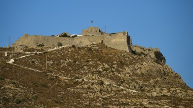 Historic castle on rocky peak surrounded by bright blue sky, Pandeli Castle, Castle, Leros