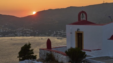 Silhouette of a chapel at sunset with sea and mountains in the background, Profitis Ilias Church,