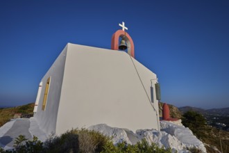 Simple chapel with bell on a hill, blue sky in the background, Profitis Ilias Church, Prophet Elias