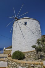 White windmill with propeller and rock garden under blue sky on an island, Pandeli Castle, Castle,