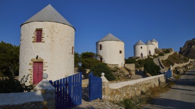 Four windmills behind a blue gate, along a road, Pandeli Castle, Castle, Leros Fortress, St John's