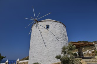 Single white windmill with large propeller under clear blue sky, Pandeli Castle, Castle, Leros