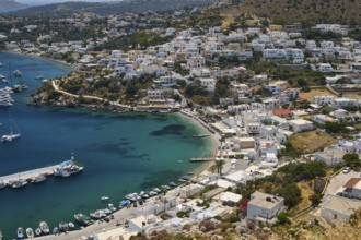 Panoramic view of a Greek coastal town with houses and yachts on the clear blue sea, Pandeli