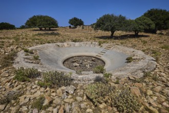 Round concrete construction in a barren landscape with trees and stones, Lost Place, Air Defence