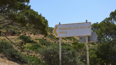 Road sign with directions surrounded by green trees and hills, Lost Place, Air Defence Position,