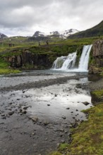 Hikers, tourists at Kirkjufellfoss waterfall, Kirkjufellsa river, Grundarfjördur, Snæfellsnes