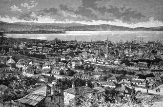 Cityscape of Hobart on the River Derwent, church in the centre, low buildings, harbour with tall