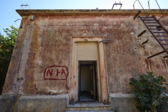 Lost Place, Dilapidated building with red facade and rusty staircase under blue sky, Radio Station,