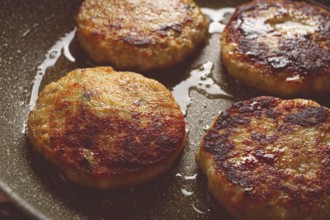 Fried chicken cutlets, with vegetables, in a frying pan, homemade, no people