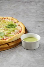 This dish features a freshly baked pizza with a golden crust adorned with toppings like fresh