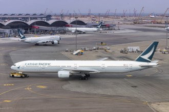 A Cathay Pacific Boeing 777-300 aircraft with the registration B-HNH at Chek Lap Kok Airport (HKG)