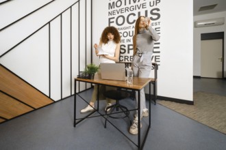 Women watch the download dynamics of their new health monitoring app on their laptop online