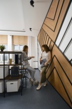 Two women stayed up late discussing their app for monitoring women's health in a startup office