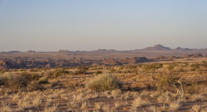 Desert landscape in the evening light at sunset, barren landscape with hills of stacked rocks,