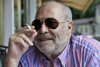 Portrait of an elderly gentleman with a beard, sunglasses and a cigarette in his hand, Tegernsee,