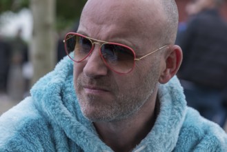 Portrait of a young man with sunglasses and fluffy jacket, Baden-Württemberg, Germany