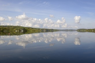 View over the Möhnesee, Möhnesee tower, red and white buoy, blue cloudy sky, reflection on the
