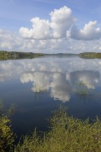 View over the Möhnesee, blue cloudy sky, reflection on the water surface, Möhnetalsperre, North