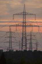 Power lines in front of a bright orange sky at sunset, Waiblingen, Baden-Württemberg, Germany