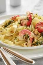 A delicious plate of fettuccine allo scoglio features perfectly cooked pasta topped with shrimp and