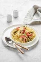 Fettuccine allo Scoglio is elegantly presented on a white plate, featuring fresh seafood like