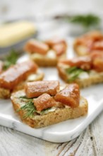 Close-up view of exquisite open-faced sandwiches with herring caviar on a slice of bread, garnished
