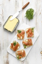 Delicious smoked herring caviar layered on cream cheese spread over crusty bread slices, topped
