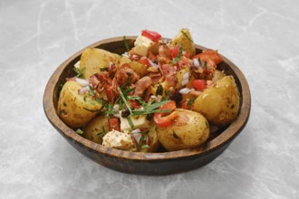Perfectly cooked baby potatoes are seasoned with herbs and topped with crispy bacon, fresh