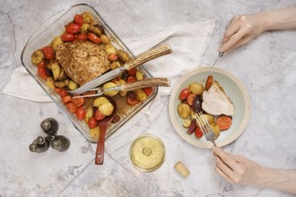 Tender roasted turkey breast rests in a baking dish surrounded by vibrant roasted vegetables. A