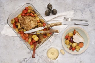 Succulent turkey breast is perfectly roasted alongside vibrant vegetables and potatoes, arranged on