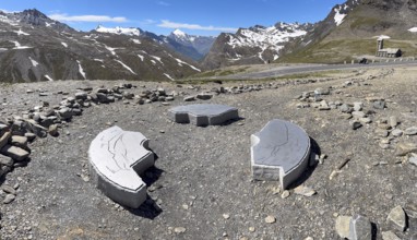 In front three orientation boards on stone for landscapes and mountain peaks at viewpoint next to