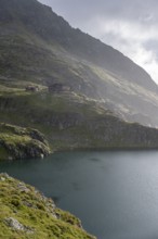 Wangenitzseehütte and mountain lake Wangenitzsee, cloudy mountain peaks in the morning, Schober