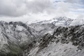 View of steep, rocky mountain landscape with fresh snow in summer, on the Vienna High Trail,