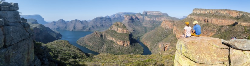 Two hikers enjoying panorama, Blyde River Canyon with Three Rondawels peak, view of gorge with