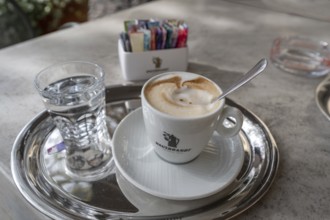 Cappuccino served with a glass of water, Bressanone, Italy