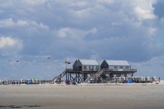 New pile dwellings on the beach with lifeguards and toilets, cloudy, Sankt Peter Ording,