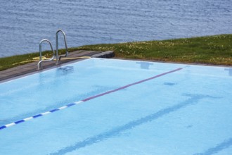 View from above of swimming pool by the sea, thermal bath, heated outdoor pool in Hofsos at the