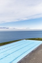 View from above of infinity pool by the sea, thermal bath, heated outdoor pool in Hofsos by