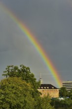 Rainbow over the city of Augsburg, in the centre of the picture the hotel tower, Augsburg, Bavaria,