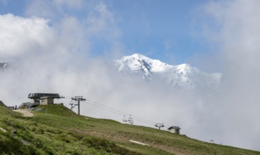 Ski lift in the Domaine de Balme ski area at Col de Balme, in summer, behind the summit of Mont