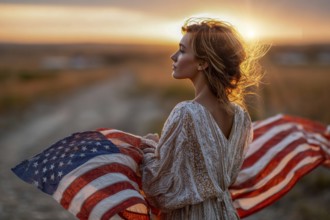 Beautiful attractive patriotic young woman with the American flag held in her standing in the