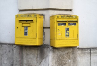 Two mailboxes, yellow, on the wall of a house, Épernay, Champagne, Marne, France