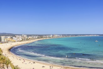 Aerial view at a tourist resort area with sunbathing people on the sand beach by the blue