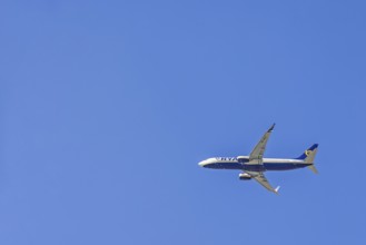 Ryanair passenger plane flying in a blue sky