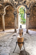Interior at Banys Arabs Baths with old amphoras, a historic site with Islamic architecture, Palma