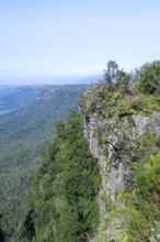 Tourist on a viewing platform at the canyon, view at God's Window, canyon landscape, near Graskop,