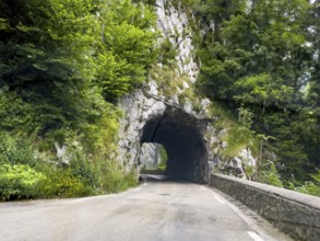 Narrow single-lane tunnel through rocks on departmental road D512 Route du Col de Porte mountain