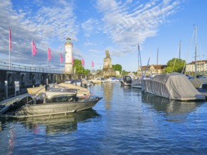 Harbour with lighthouse and lion statue in Lindau, Lake Constance, lake, blue sky, morning, boats,