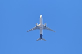Aeroplane flies high in the clear blue sky and symbolises wanderlust, Germany